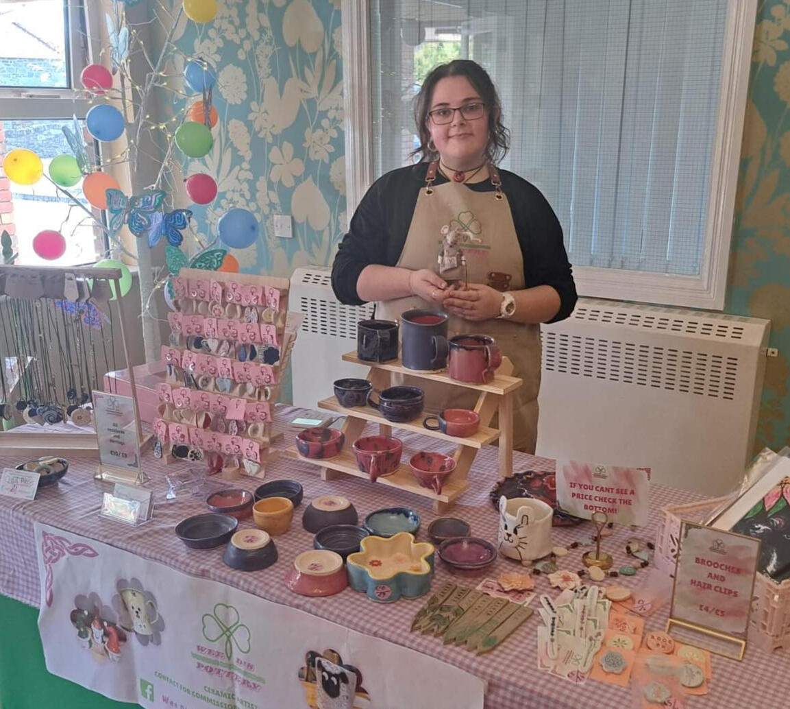 Dearbhla at a craft fair with a wide selection of pottery products